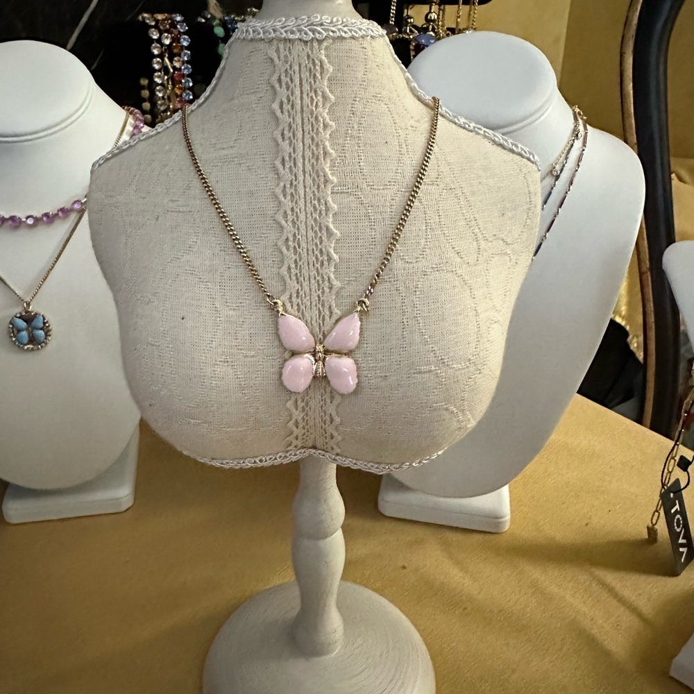 Butterfly pendant in light pink on a simple chain